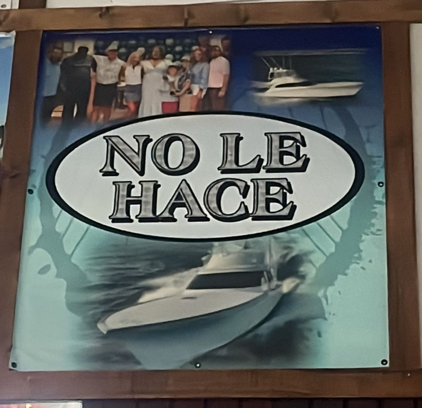 The winning No Le Hace brag board banner framed in wood at the Nauti Rooster