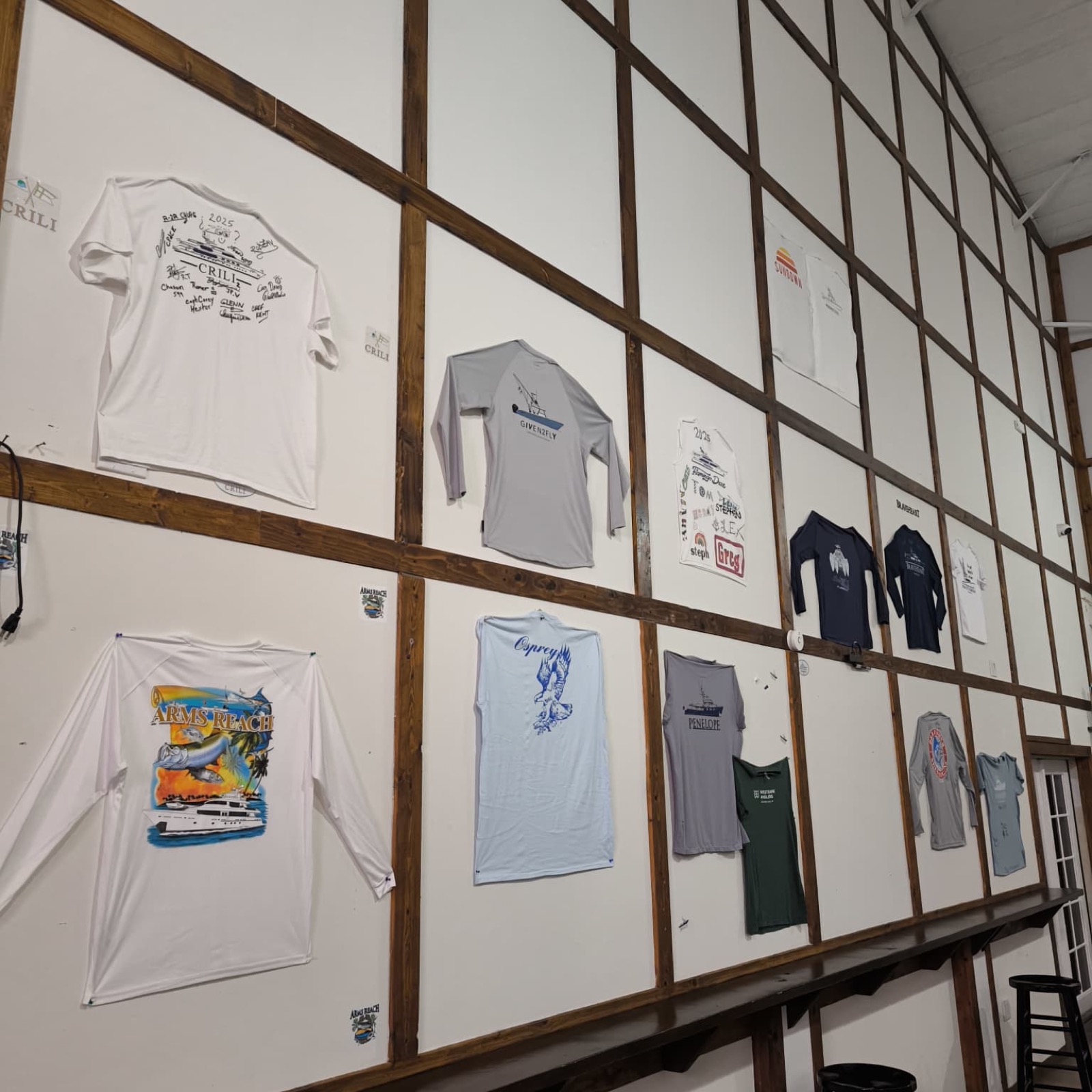Wall of signed boat shirts and memorabilia squares at the Nauti Rooster
