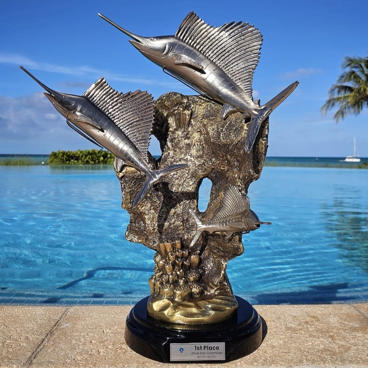 Chub Cay Invitational first-place trophy of three sailfish beside the infinity pool