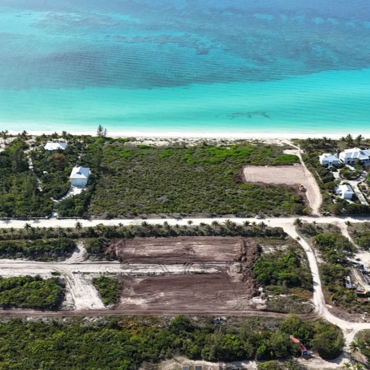 Aerial view of cleared home lots along the road parallel to Queen's Beach