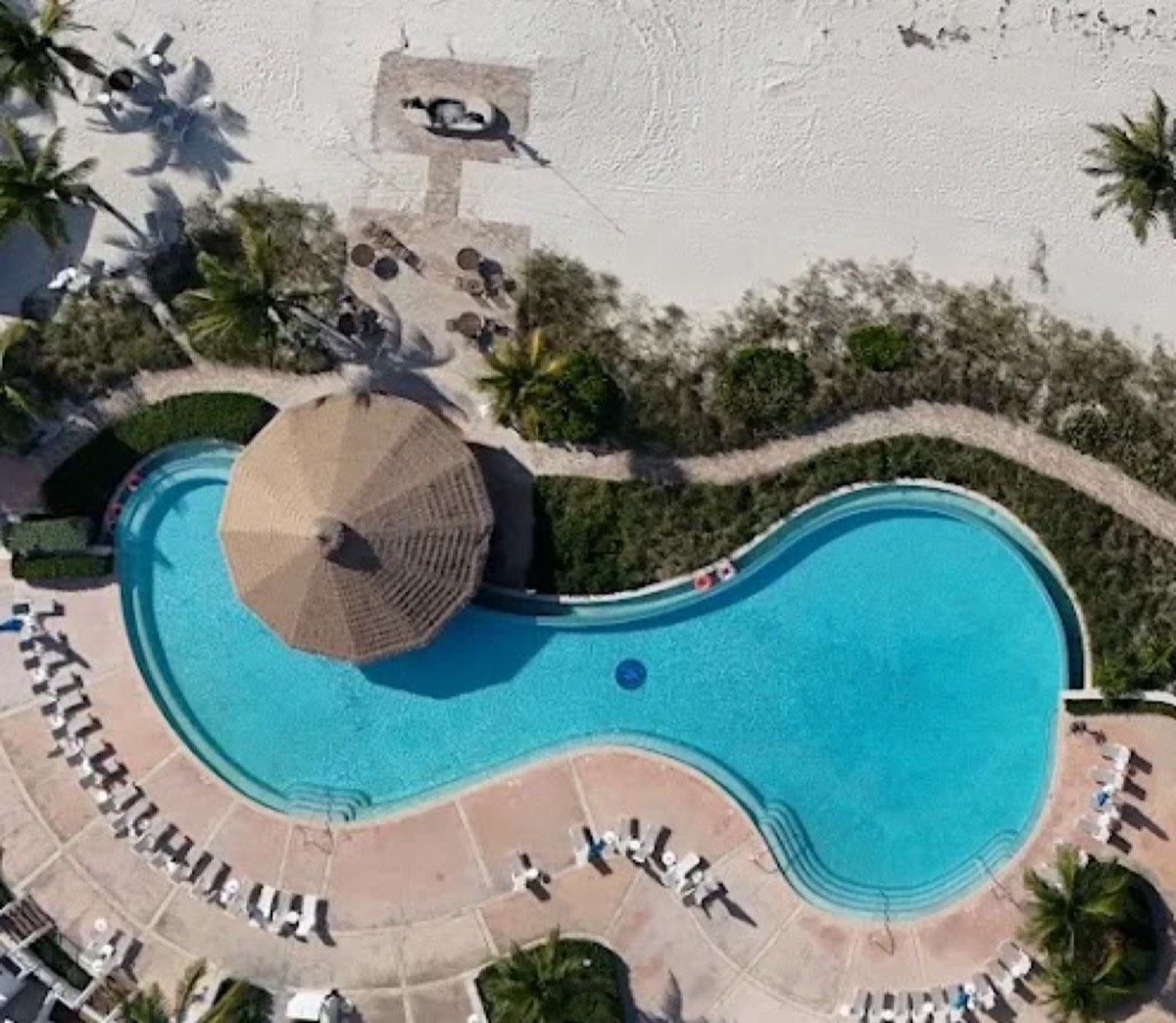 Aerial view of the Chub Cay pool and beachfront with its thatched-roof bar