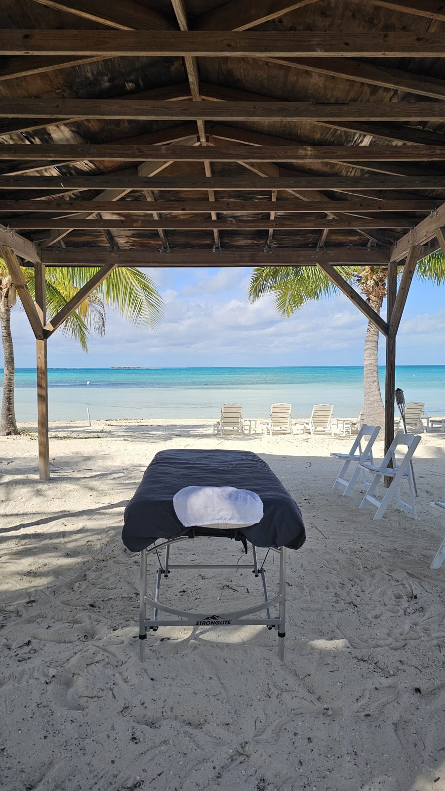 A massage table set up on the beach